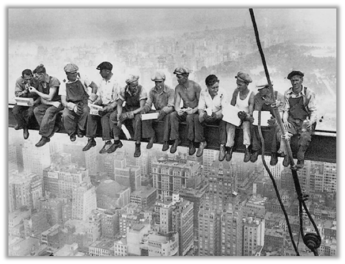 Men eating lunch atop a skyscraper they are building in New York City