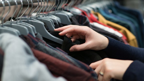 Woman's Hands Selecting Cloths in Fashion Store