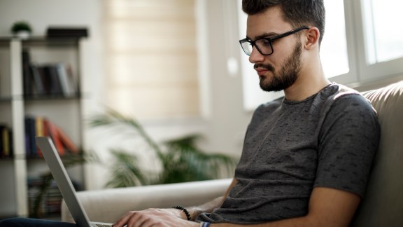 Young man using laptop at home