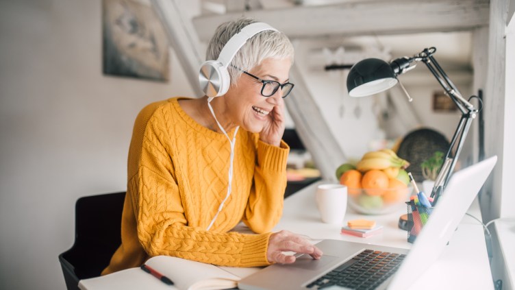 Happy mature woman doing business from home