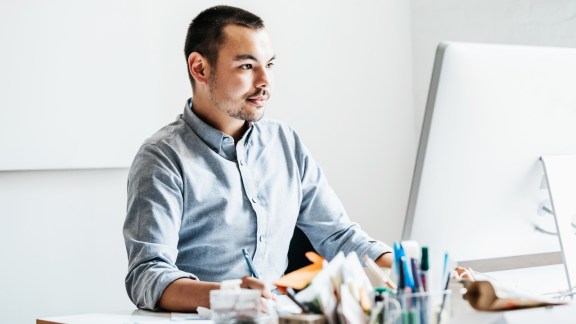 A startup business employee working on his computer at the office.