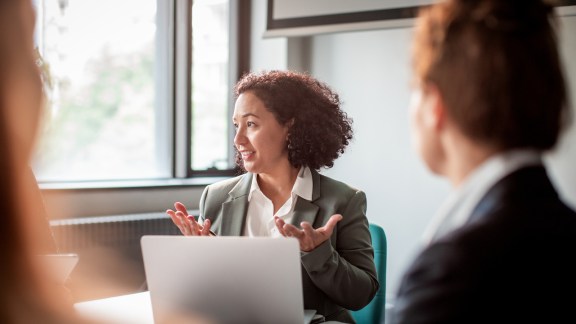 Close up of a group of business people having a meeting in a conference room regarding learning initiatives