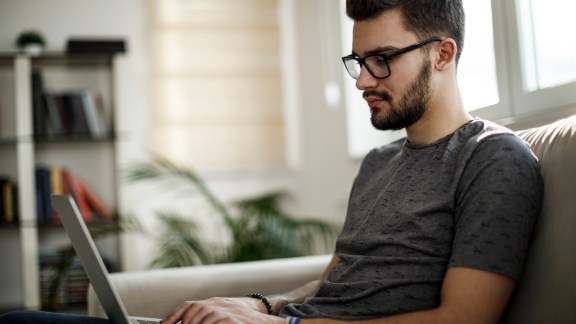 Young man using laptop at home