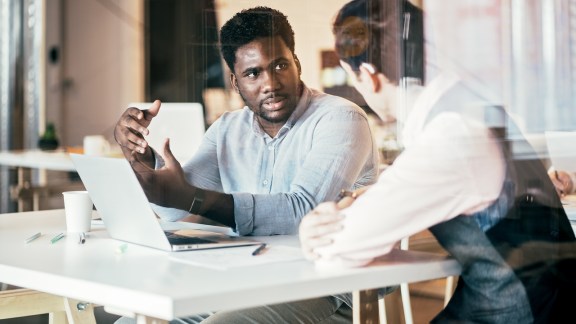 Freelance multi-ethnic group of people working together in rented office