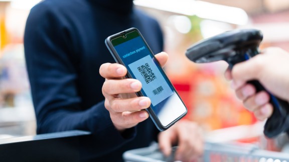 asian man contactless payment with qr code in supermarket