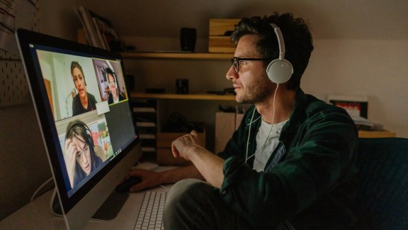 Photo of a man having a video conference call with his colleagues