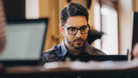 Businessman wearing glasses while working in creative office