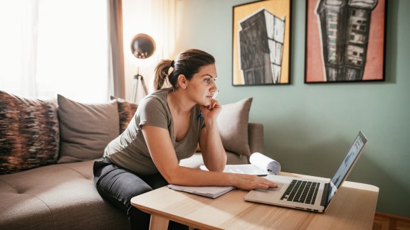 Woman working from home due to restrictive measures, lockdown and quarantine due to pandemic Coronavirus