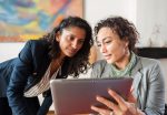 Two business women with tablet computer