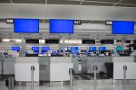 Blue screen monitor at airport ticket counter.