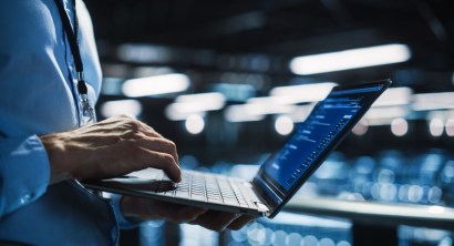 Data Center Programmer Using Digital Laptop Computer, Maintenance IT Specialist. Cloud Computing Server Farm System Administrator Working on Cyber Security for Iaas, saas, paas. Closeup Focus on Hands