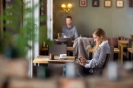 Side view of pregnant woman using digital tablet at cafe