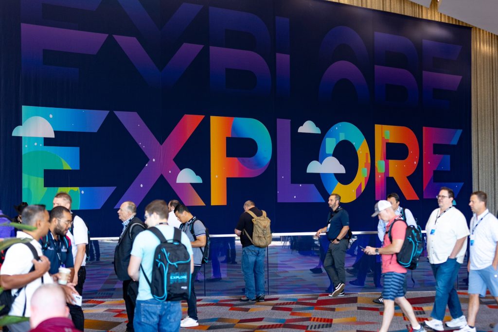 VMware Explore 2024 Las Vegas Interior branding above escalators with attendees walking by